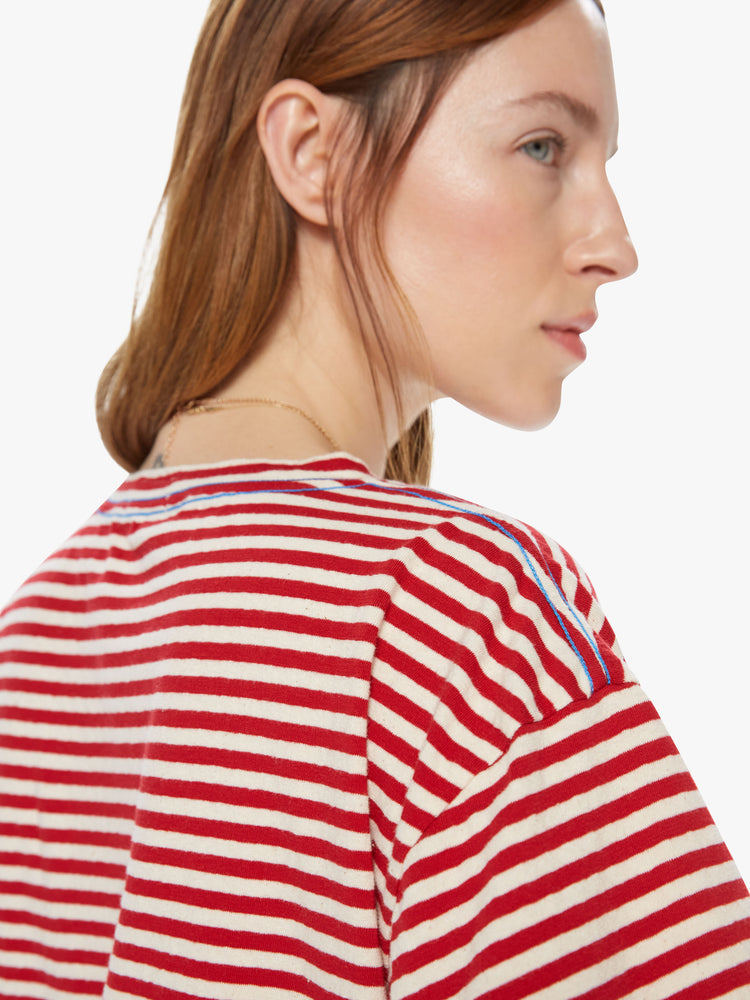 Back shoulder detail view of a red a white striped crew neck tee featuring dropped shoulders and a boxy cropped fit.