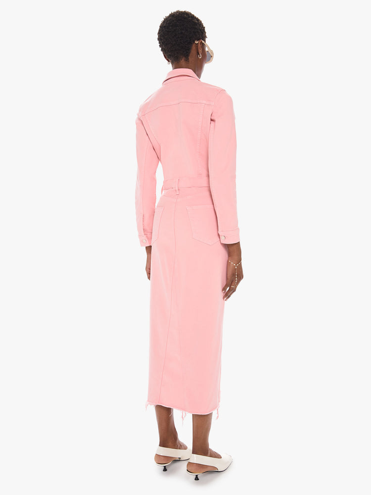 Back view of a women's light pink button down denim dress with a long sleeves and a frayed midi length hem