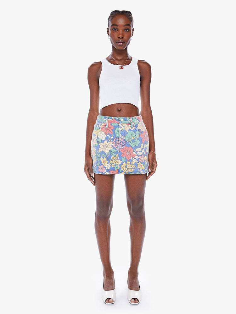Front view of a woman denim mini skirt with a high rise, button-fly, slim fit and thigh-grazing hem in a faded floral print.