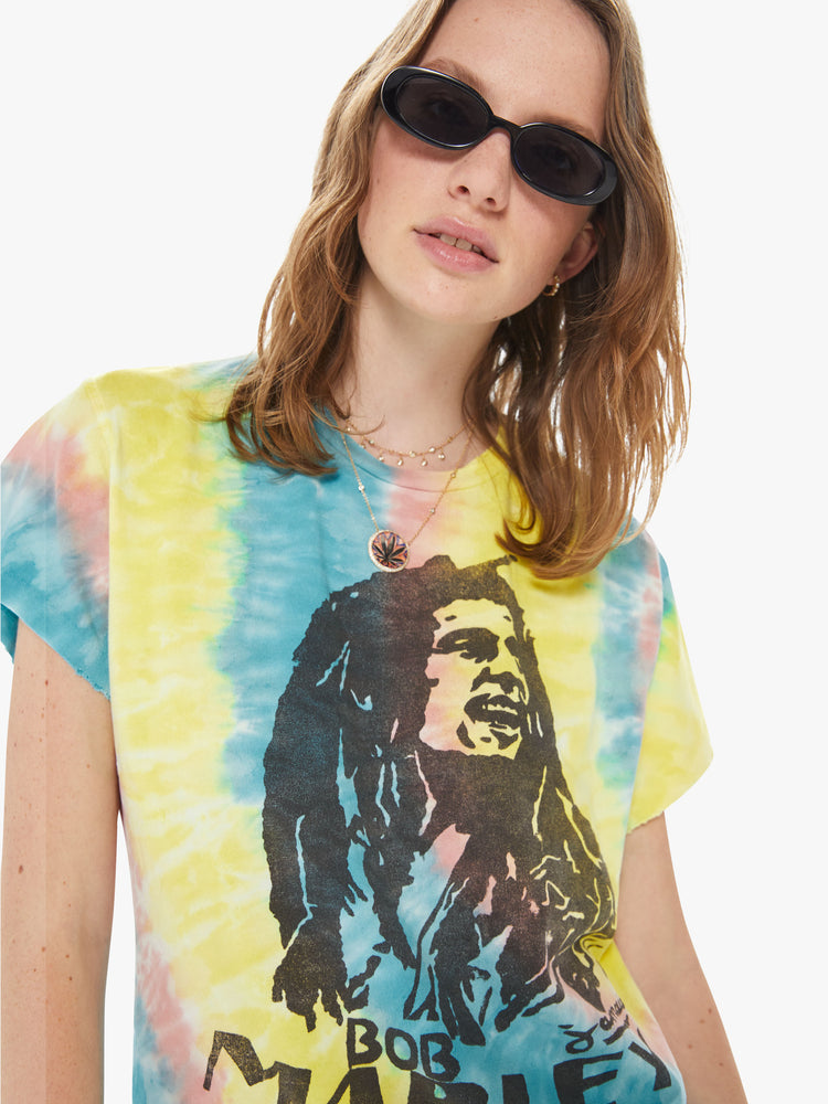 Front close up view of a woman wearing a tie dye crew neck tee featuring an oversized fit and a "BOB MARLEY" graphic.