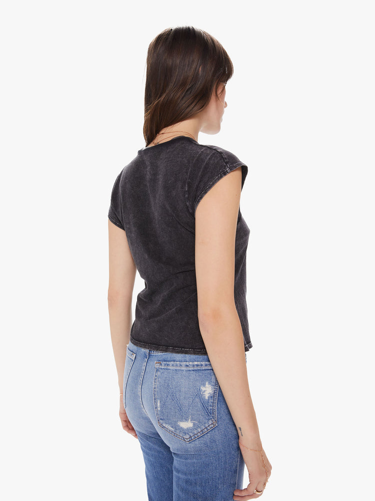 A back torso view of a Womens asymmetrical sleeve top in a black mineral wash