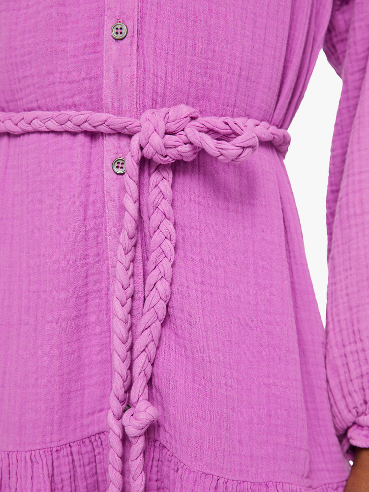 Front close up view of a womens purple button down dress featuring a flowy fit and a braided rope tie.