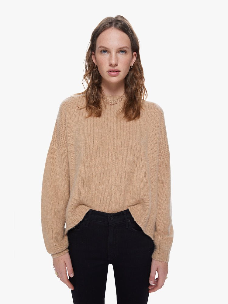 Front view of a women's camel brown knit sweater featuring a scoop neck, a center seam, and a loose fit.