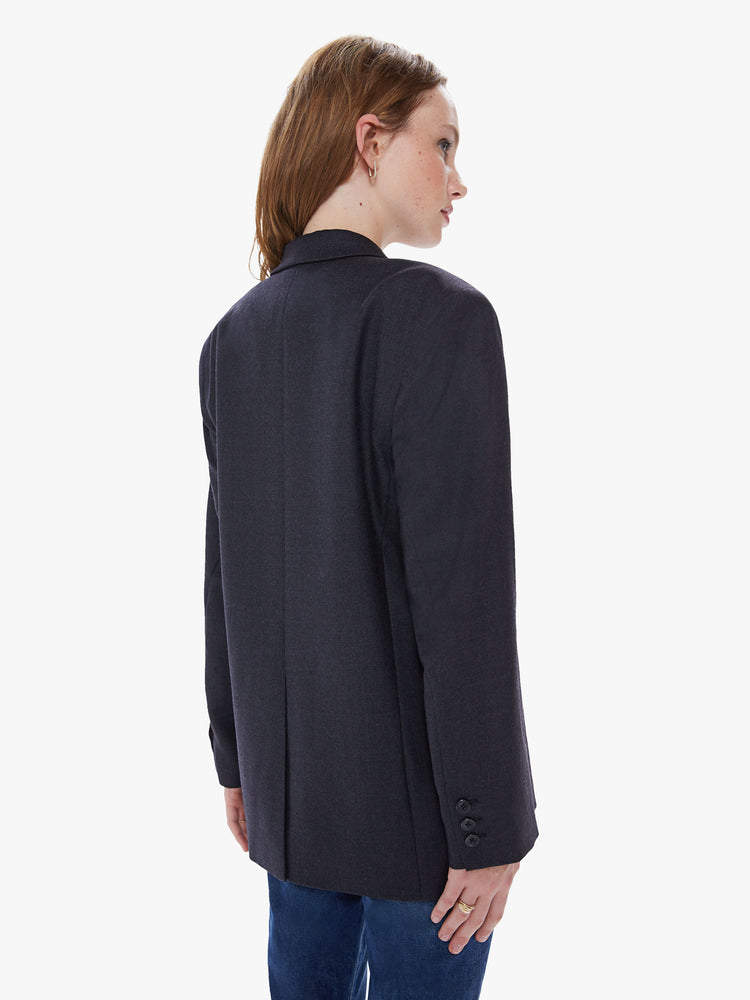 Back view of a womens charcoal blazer featuring an oversized fit, padded shoulders, and extra wide collar.