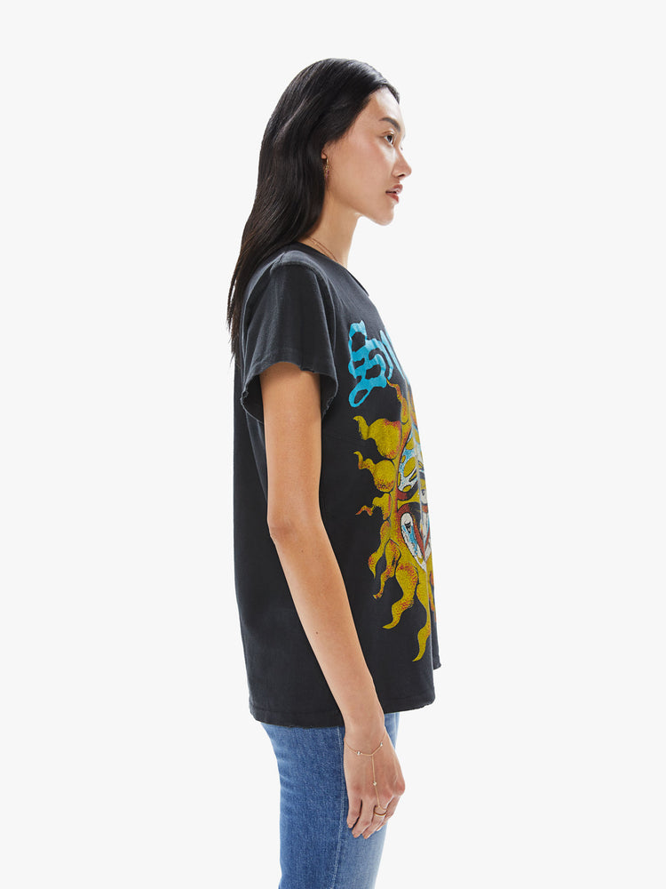 Side view of a woman wearing a faded black crew neck tee featuring a large "Sublime" sun graphic.