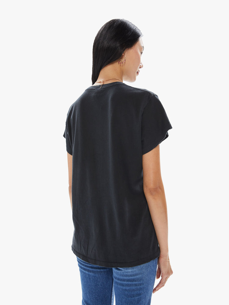 Back view of a woman wearing a faded black crew neck tee featuring a large "Sublime" sun graphic.