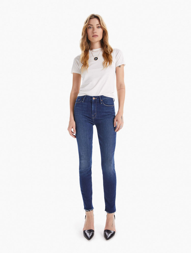 Front view of women's medium blue mid rise cropped skinny with zip fly and frayed hem