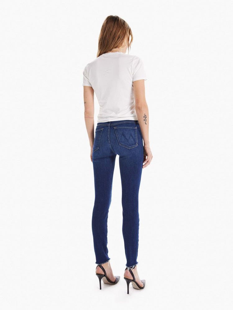 Back view of women's medium blue mid rise cropped skinny with zip fly and frayed hem