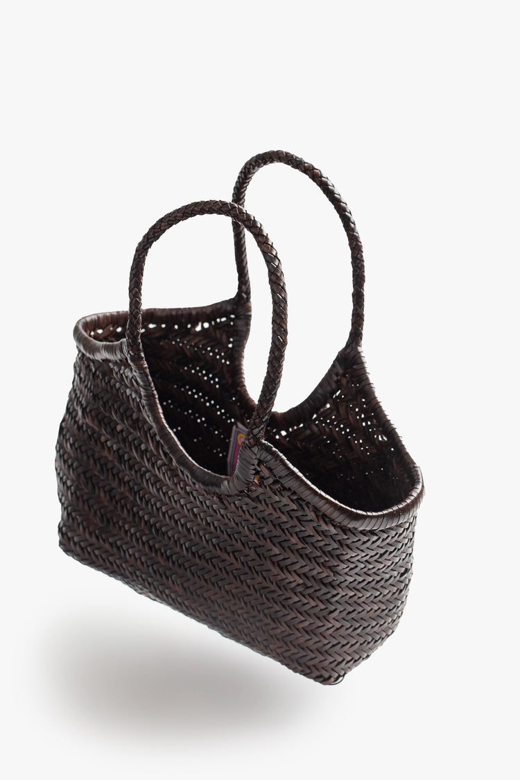 Side view of a dark brown, woven leather bag.