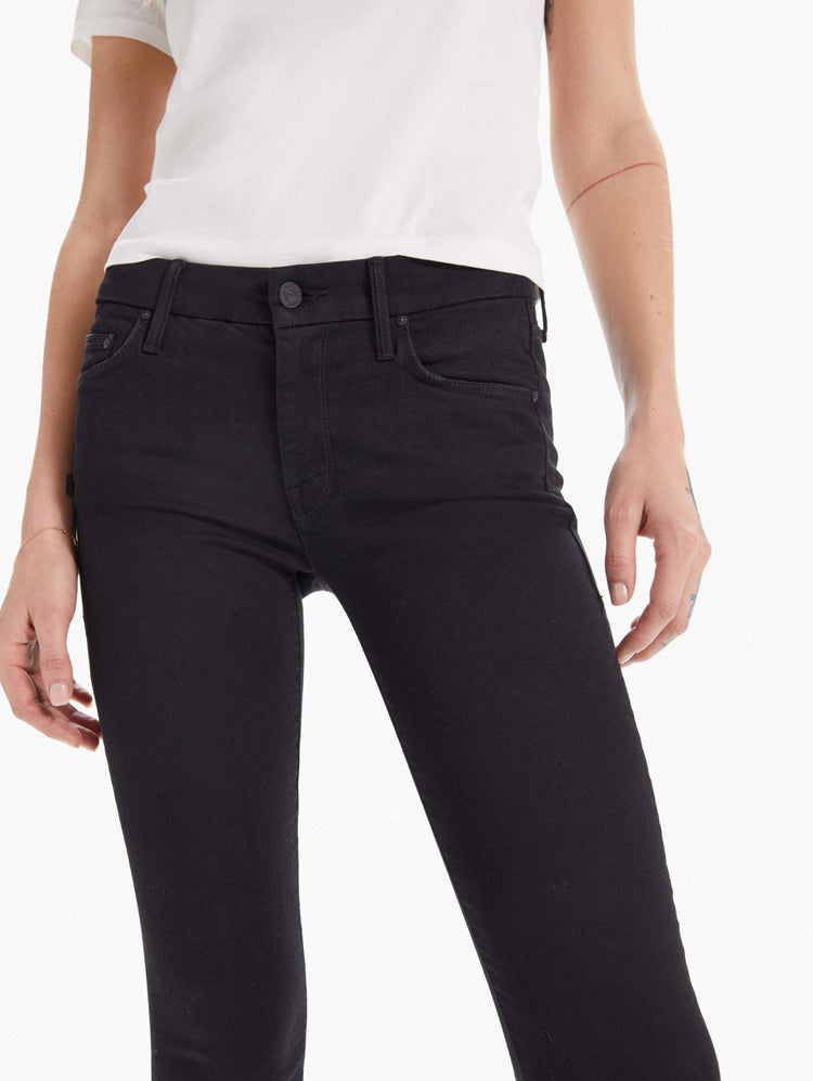 detail view of women's black mid rise skinny jean with zip fly and clean hem