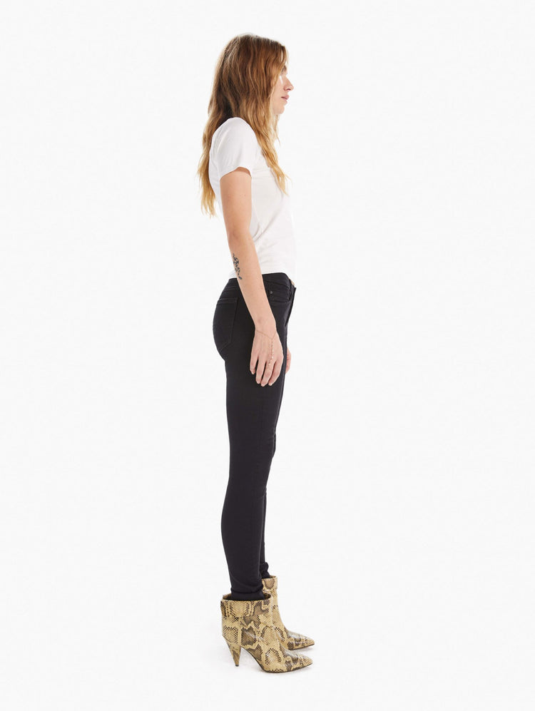 side view of women's black mid rise skinny jean with zip fly and clean hem