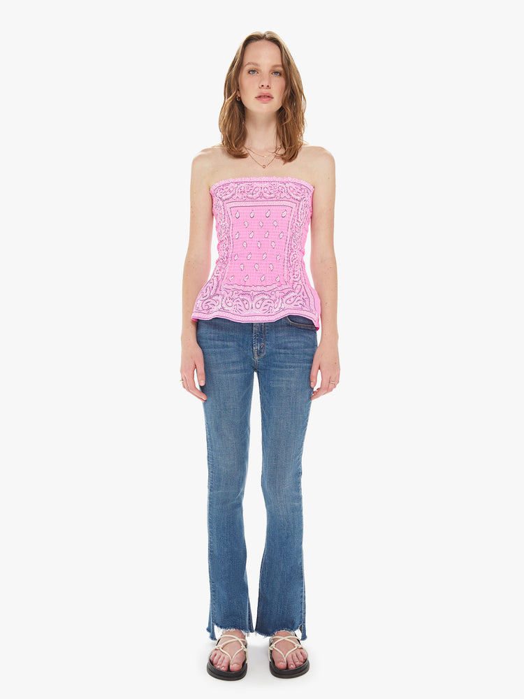 Front full body view of a women wearing a pink elastic tube top featuring a light pink bandana print.