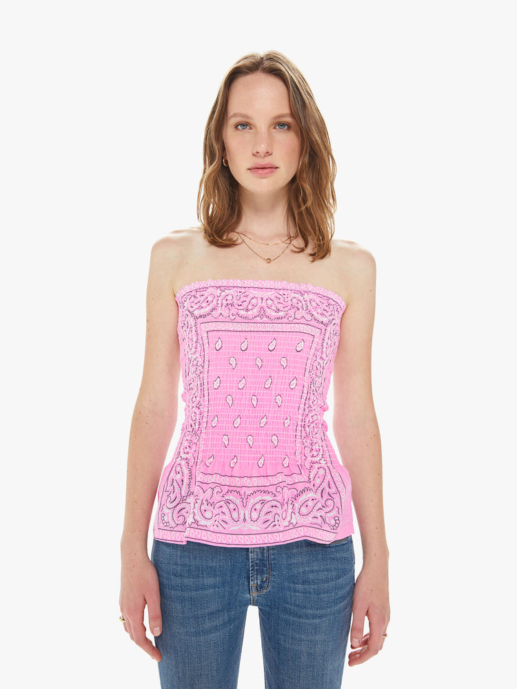 Front view of a women wearing a pink elastic tube top featuring a light pink bandana print.