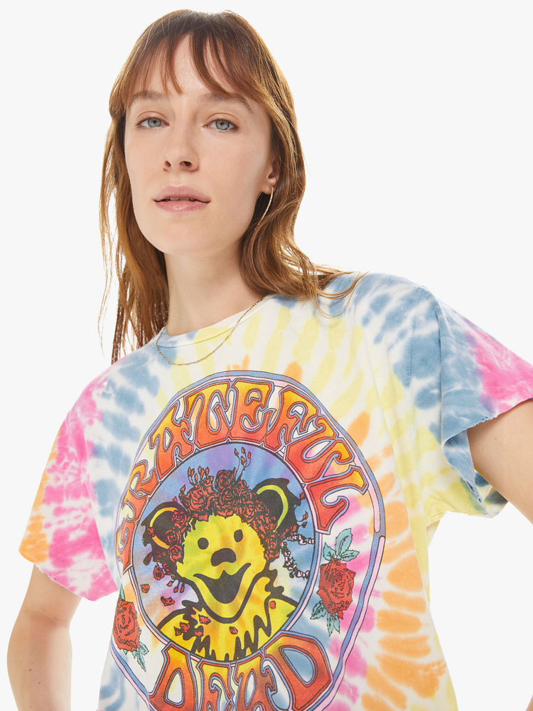 Front close up view of a woman wearing a tie dye crew neck tee featuring an oversized fit and a large "GRATEFUL DEAD" graphic.