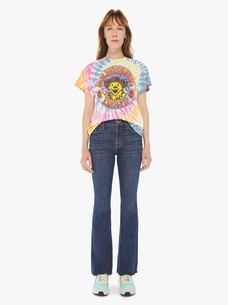 Front full body view of a woman wearing a tie dye crew neck tee featuring an oversized fit and a large "GRATEFUL DEAD" graphic.