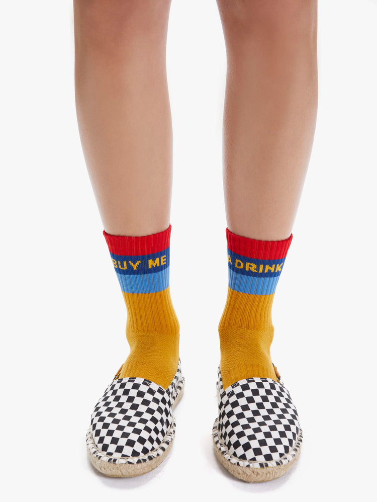 FRONT VIEW WOMEN'S YELLOW BLUE AND RED SOCK READING "BUY ME A DRINK"