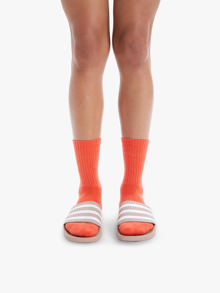 FRONT VIEW WOMEN'S MID CALF LENGTH ORANGE SOCK WITH YELLOW SIDE MOVE IT LETTERING WITH BOTTOM BLACK MOTHER LETTERING