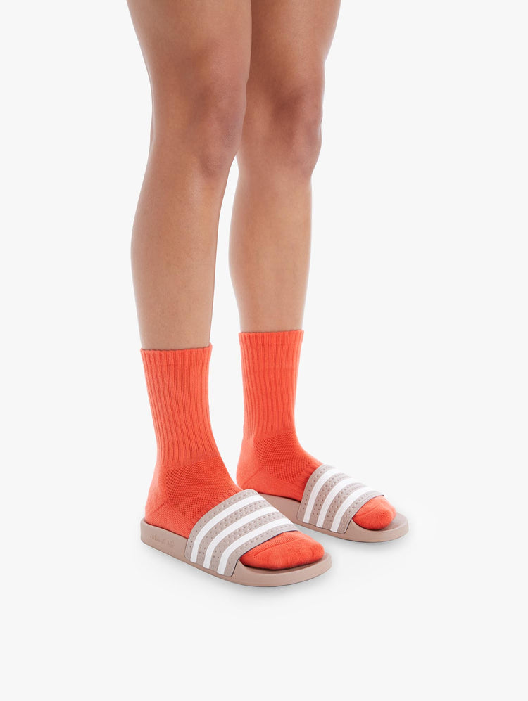 SIDE VIEW WOMEN'S MID CALF LENGTH ORANGE SOCK WITH YELLOW SIDE MOVE IT LETTERING WITH BOTTOM BLACK MOTHER LETTERING
