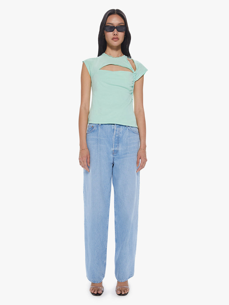 A front full body view of a Womens asymmetrical sleeve top in a mint green hue, featuring cutouts at the shoulder and chest and a braid down the left side.