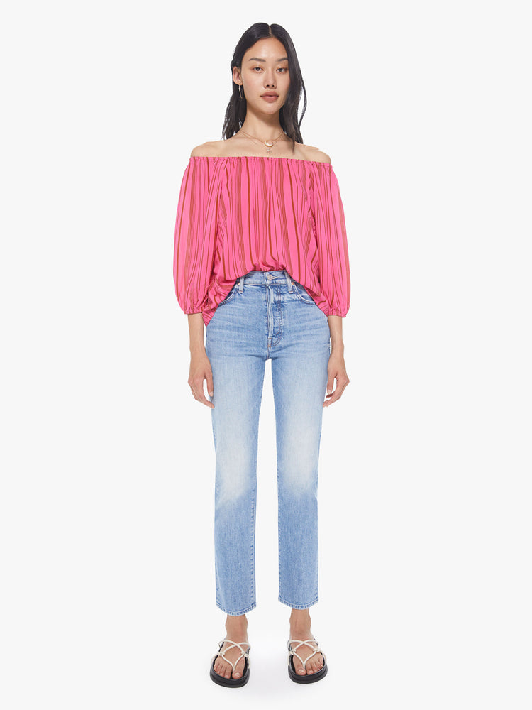 Full front view of a women's bright pink off-shoulder blouse with red vertical stripes and 3/4 sleeves