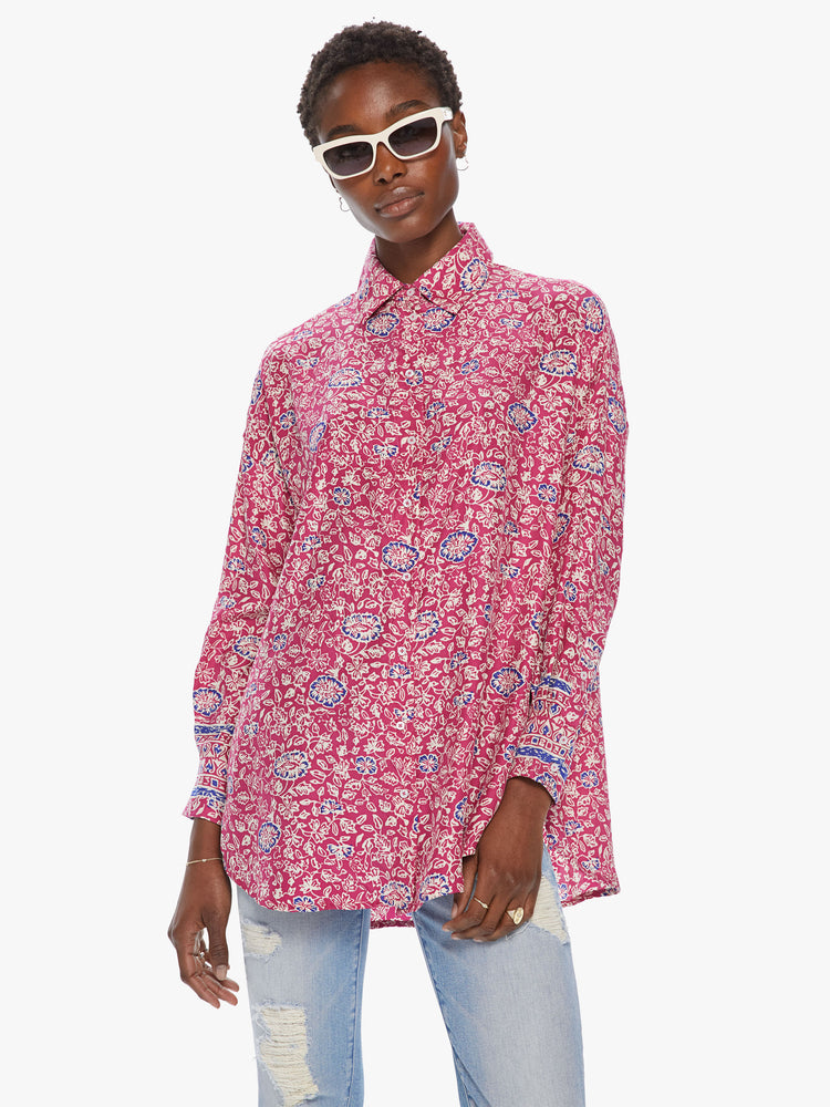 Front view of women's bright pink button front long sleeve shirt with all over floral print