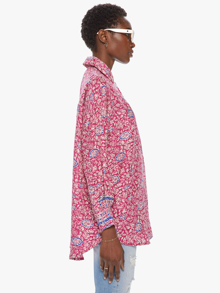 Side view of women's bright pink button front long sleeve shirt with all over floral print