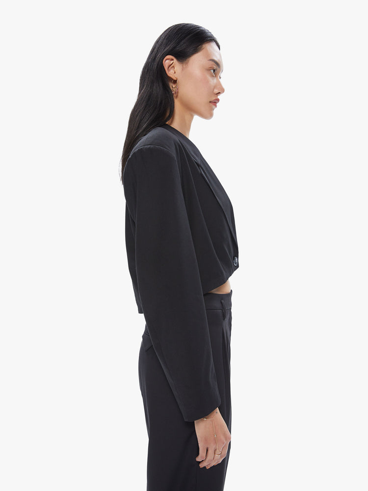 Side view of a women's cropped black suit jacket