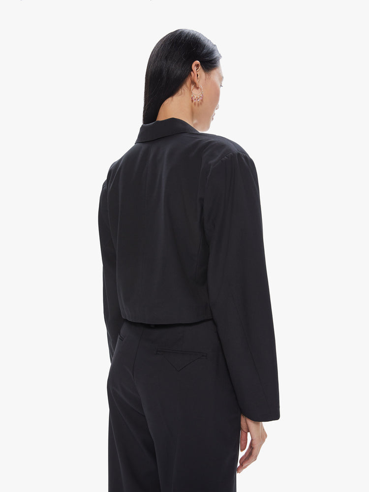 Back view of a women's cropped black suit jacket