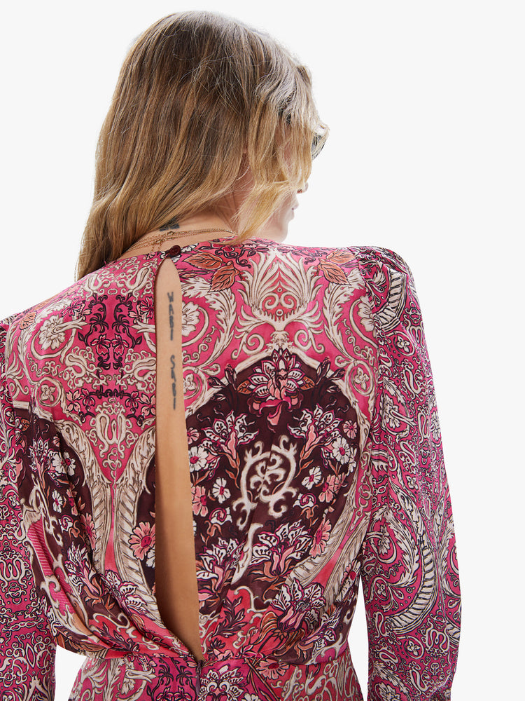 Back detail view of a women's long sleeved mini dress in an all-over pink print