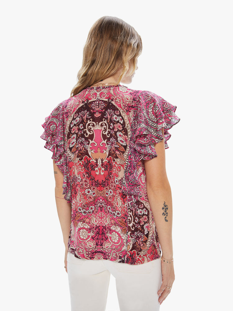 Back view of a women's pink top with an all-over paisley print and ruffle sleeves