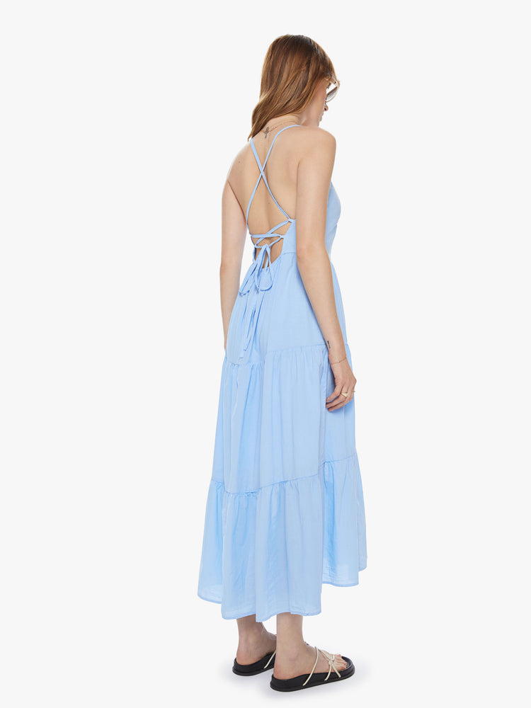 Back view of women's light blue tiered midi dress with lace up open back detail