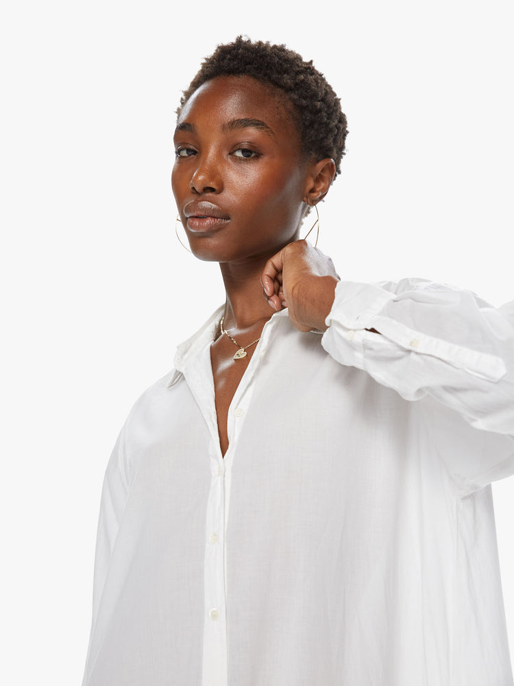Front detail view of a women's long white collared shirt dress with long sleeves