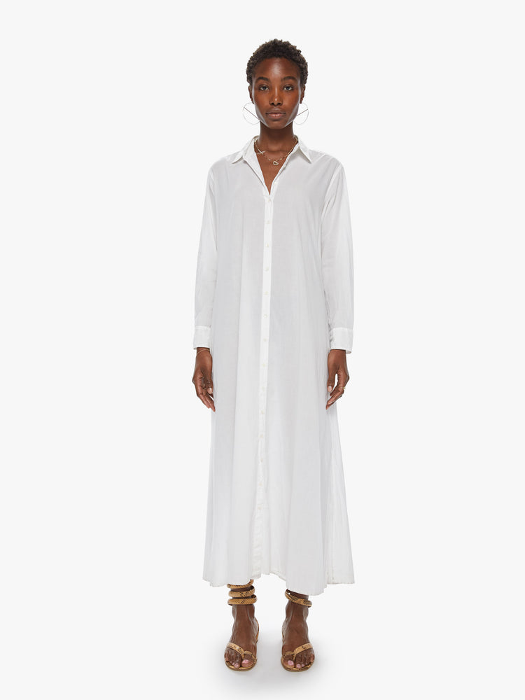 Front view of a women's long white collared shirt dress with long sleeves