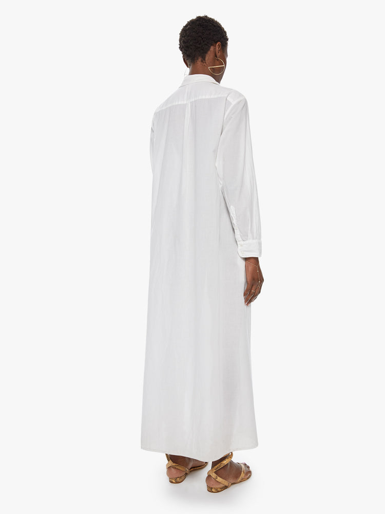 Back view of a women's long white collared shirt dress with long sleeves