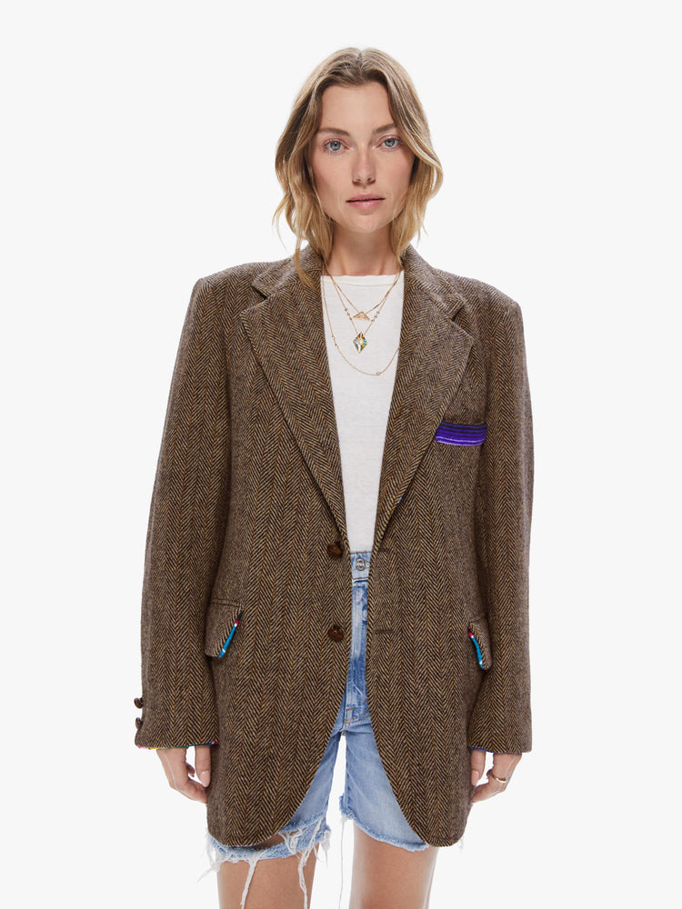Front view of a woman wearing a vintage tweed blazer with sarape blanket trim details and an oversized fit.