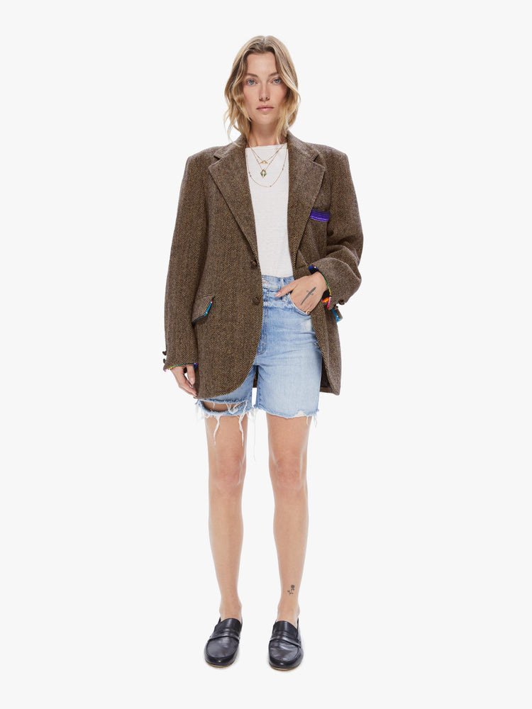 Full body view of a woman wearing a vintage tweed blazer with sarape blanket trim details and an oversized fit.