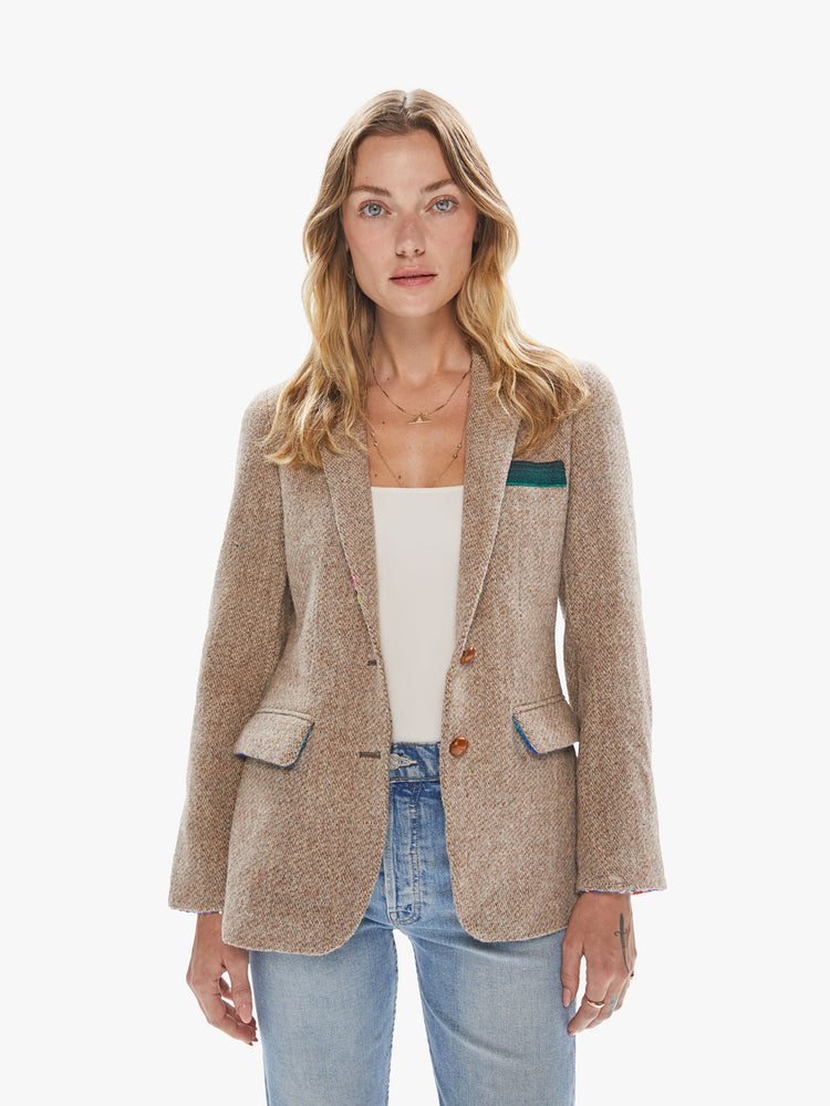 Front view of a woman wearing a light brown vintage tweed blazer with sarape blanket trim details and an oversized fit.