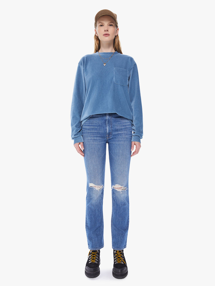 Front full body view of a women's long sleeve crew neck tee featuring a blue faded ribbed fabric, dropped sleeves, a chest pocket, and an oversized fit.
