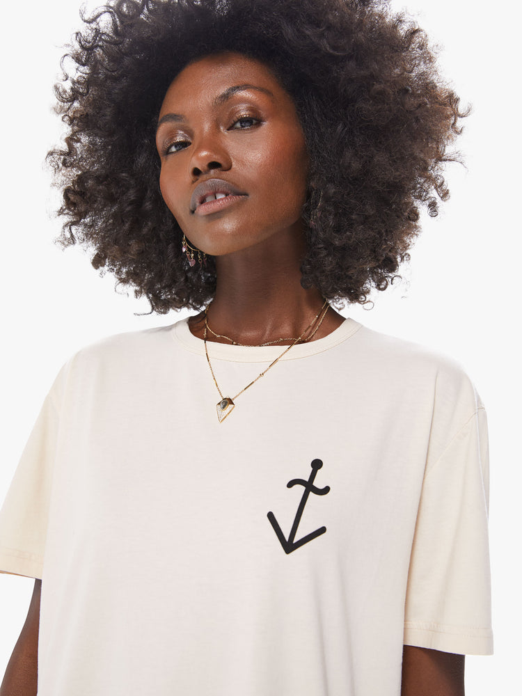 Front close up view of an ecru crew neck tee featuring an oversized fit and a chest graphic of an anchor.