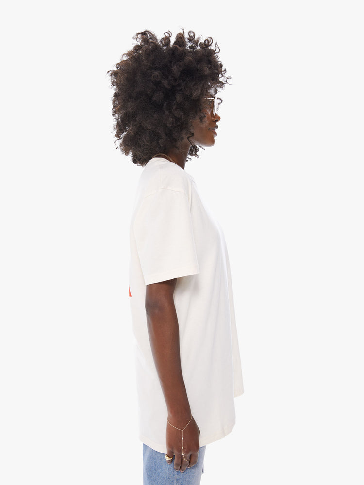 Side view of a women's ecru crew neck tee featuring an oversized fit.