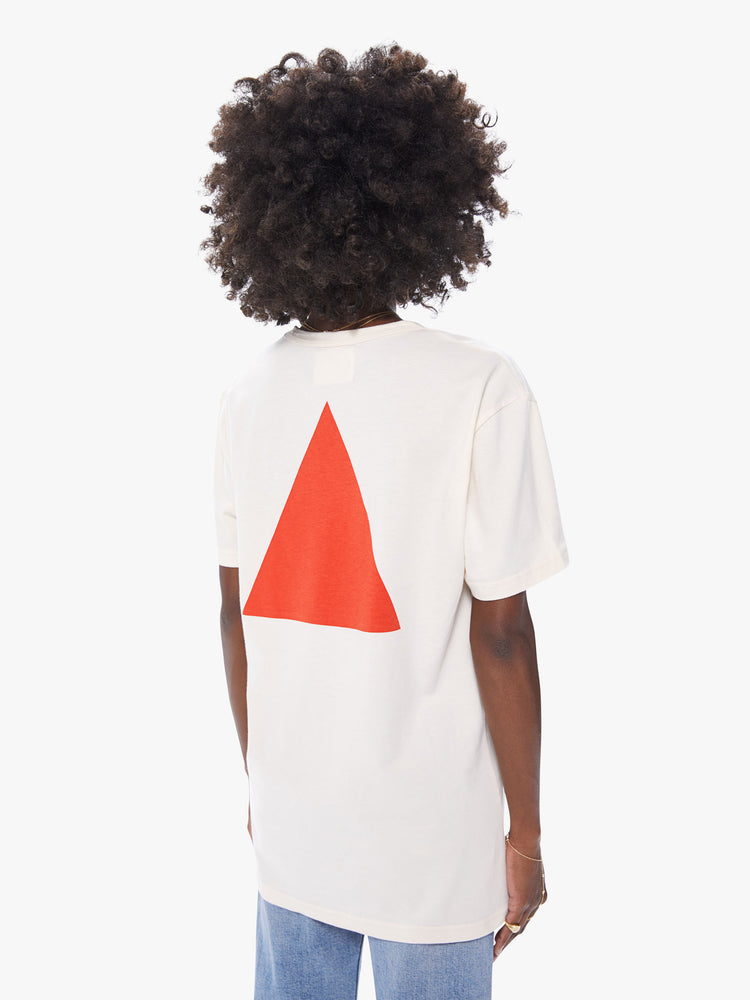 Back view of a women's ecru crew neck tee featuring an oversized fit and large red triangle graphic on the back.