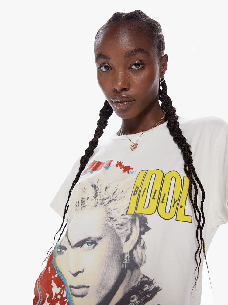 Front close up view of a woman wearing an off white crew neck tee featuring a large Billy Idol graphic and an oversized fit.