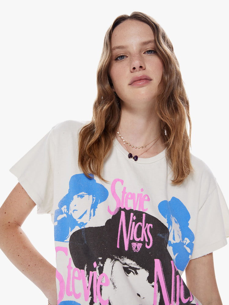Front close up view of a woman wearing an off white crew neck tee featuring a large Stevie Nicks graphic and an oversized fit.