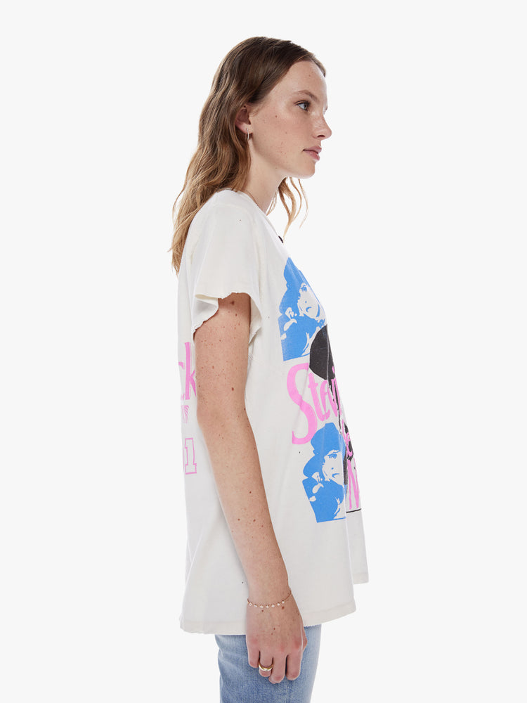 Side view of a woman wearing an off white crew neck tee featuring a large Stevie Nicks graphic and an oversized fit.