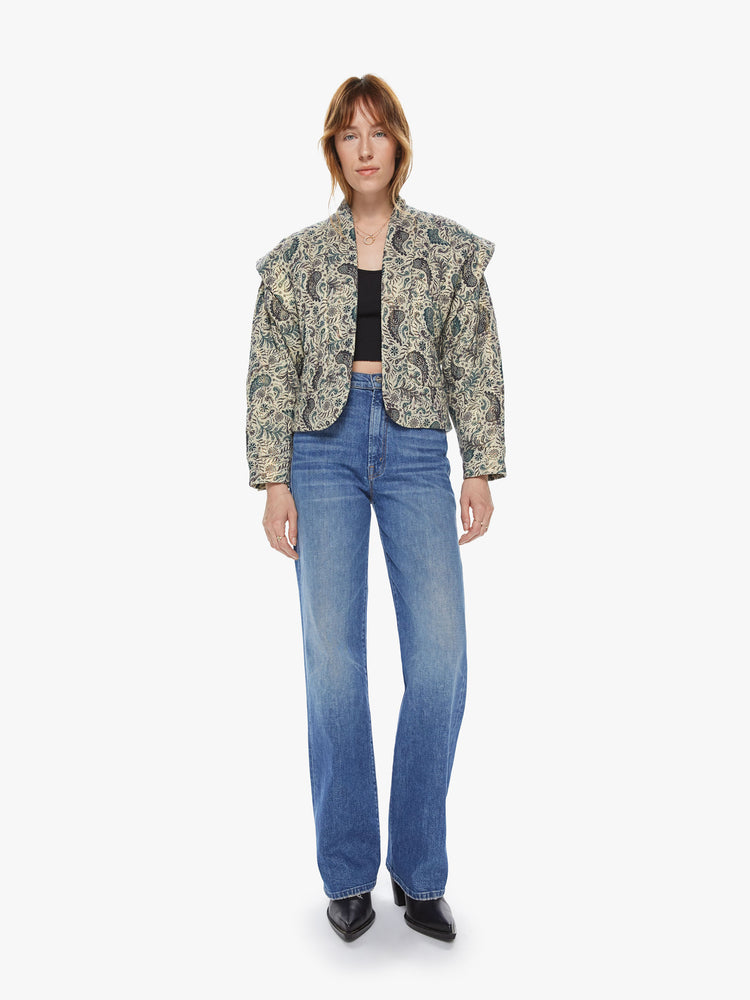 Front full body view of a woman wearing a cropped jacket featuring a neutral paisley print, a boxy fit, and dropped overlap shoulders.