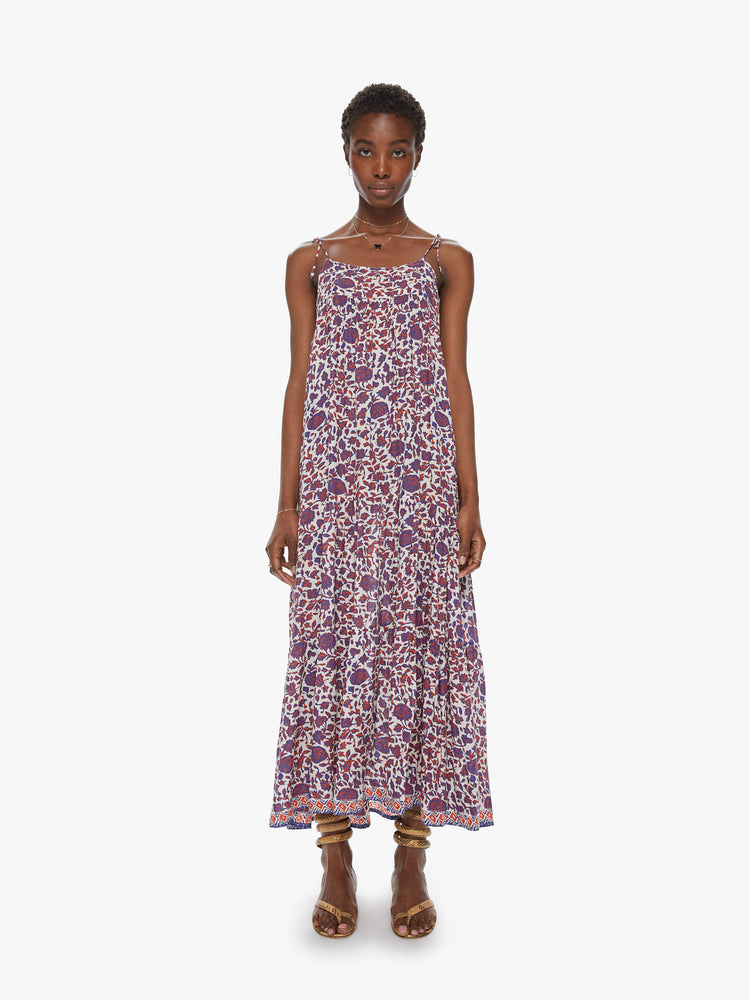 Front view of a spaghetti strap dress featuring a long, flowy fit and a blue and red floral print.