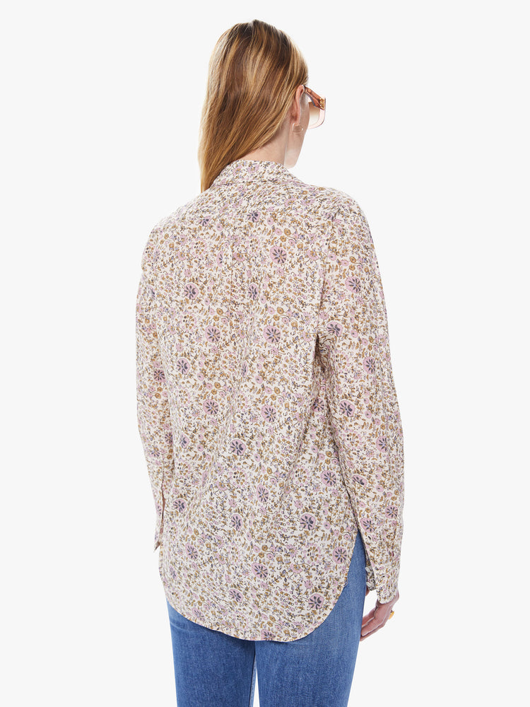 Back view of a women's cream colored button down shirt with an all-over yellow and pink floral print