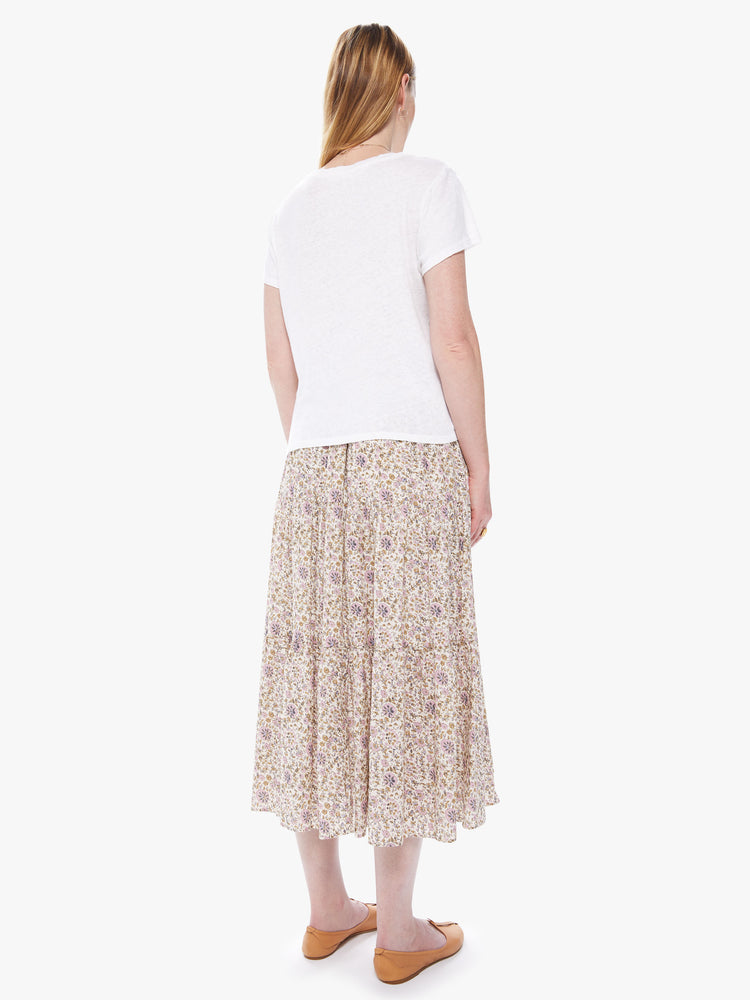 Back view of a women's cream colored midi skirt with an all-over pink and yellow floral print
