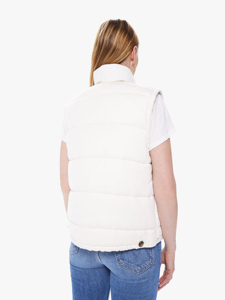 Back view of a women's ivory reversible vest with beige floral lining and tortoise buttons