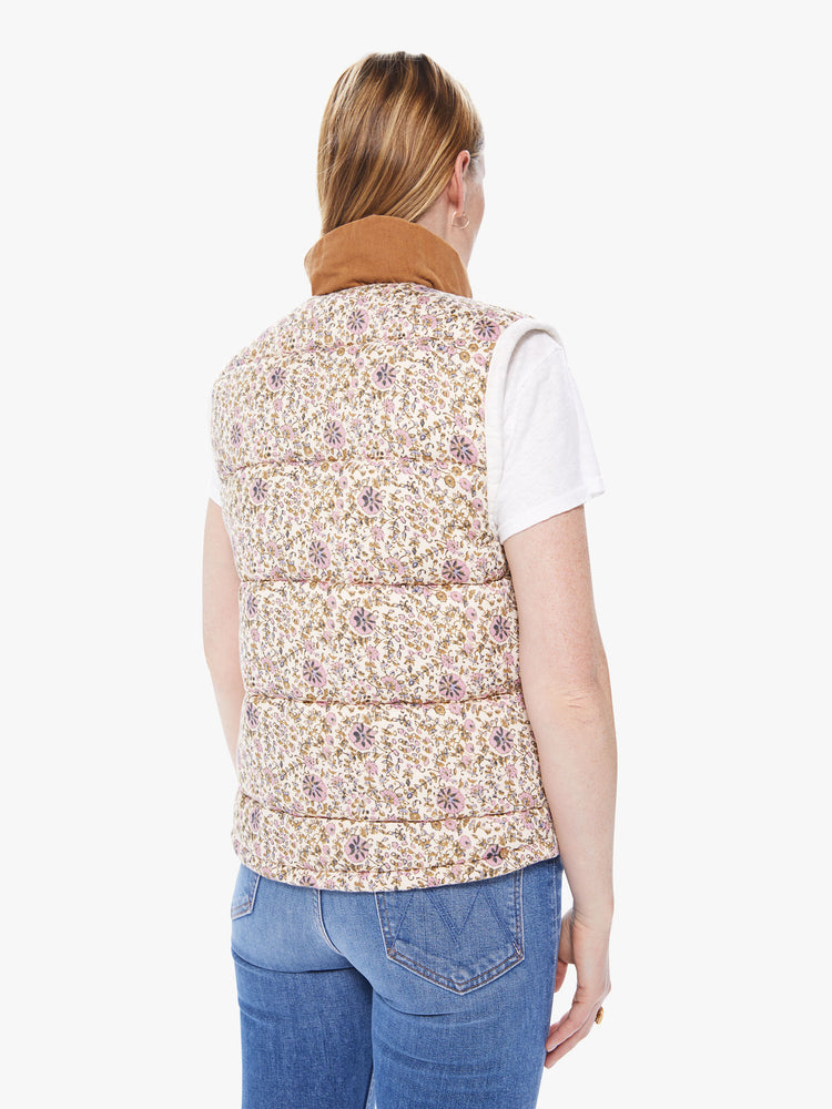 Back  view of a women's ivory and beige floral reversible vest worn reversed